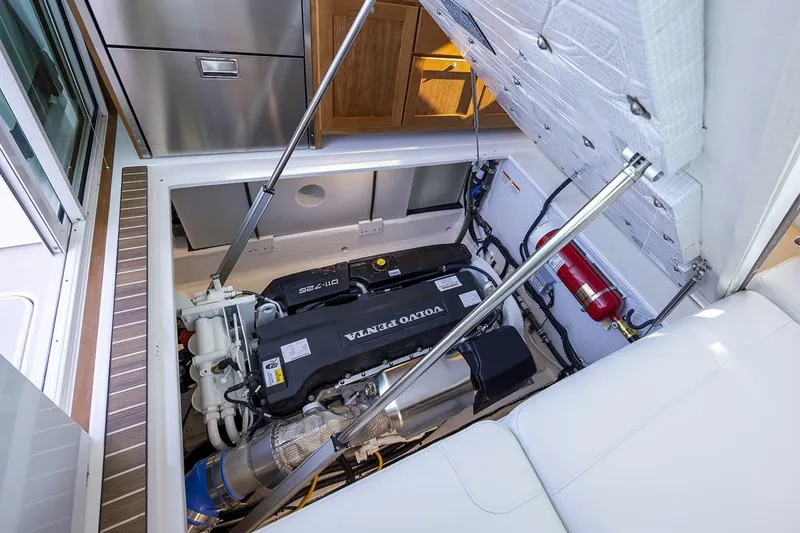 Slide: The Image of 2026 Back Cove 412 engine compartment with Volvo Penta engine and fire extinguisher. - 16