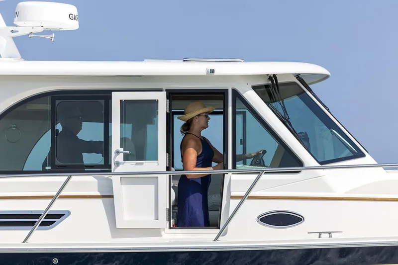 Slide: The Image of 2026 Back Cove 412 yacht with passengers, cruising on a sunny day. - 18