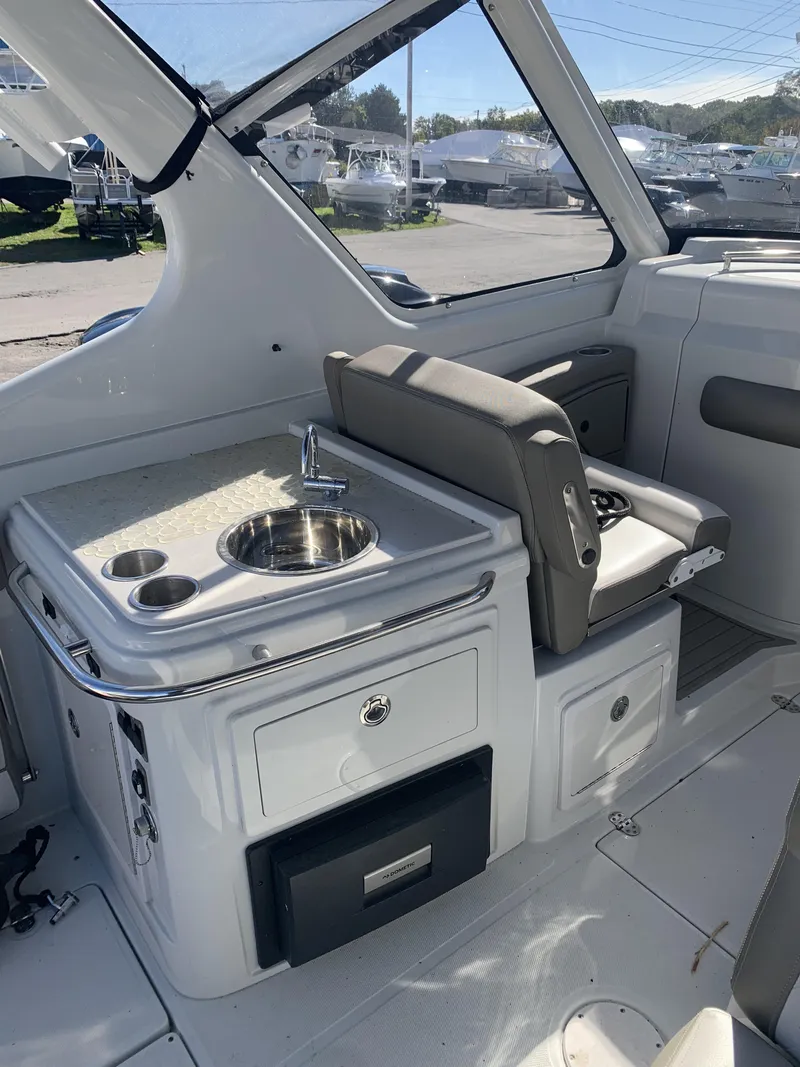 Slide: The Image of 2022 Finseeker 280 DC boat interior with steering console and seating. - 13