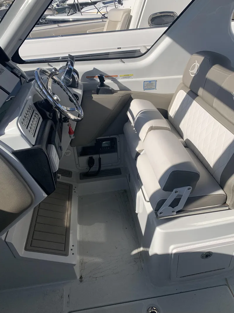 Slide: The Image of Interior of 2022 Finseeker 280 DC boat with steering wheel and seating. - 17