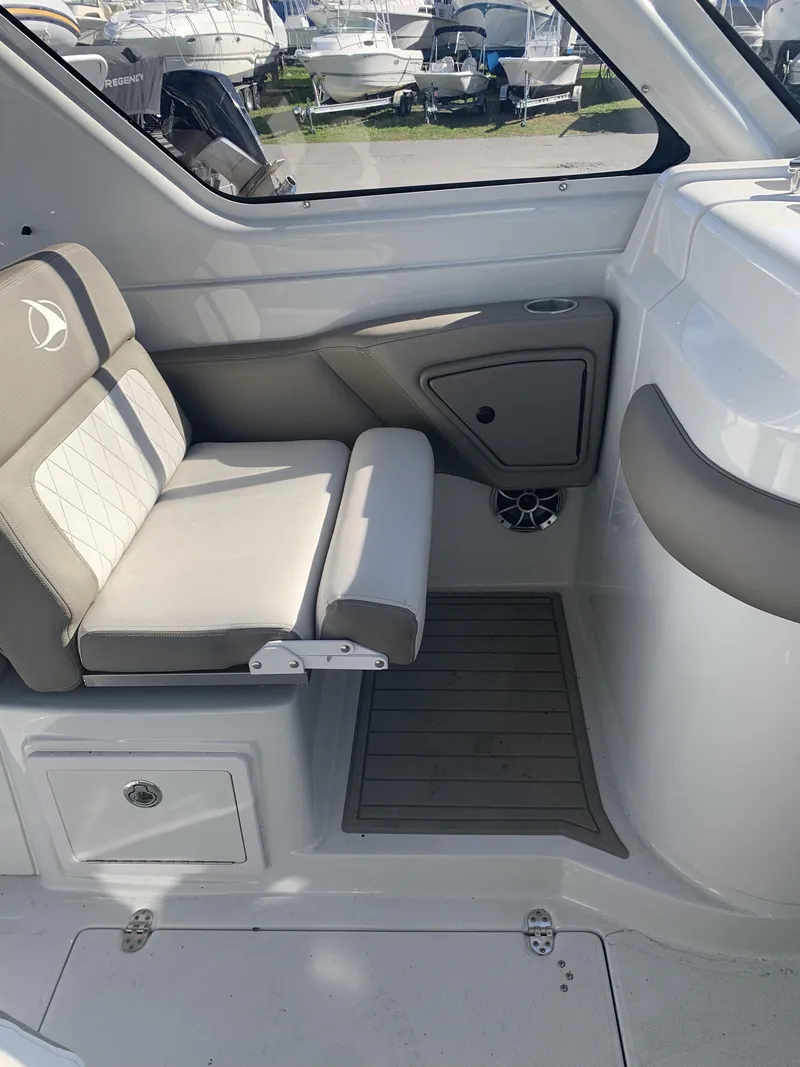 Slide: The Image of 2022 Finseeker 280 DC boat interior with cushioned seating and storage compartment. - 18