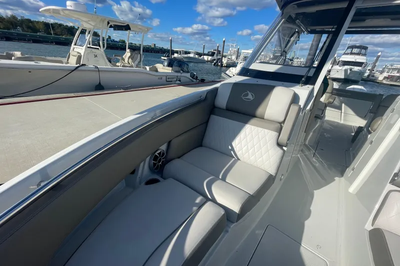 Slide: The Image of 2022 Finseeker 280 DC boat cockpit with controls and Garmin display. - 21