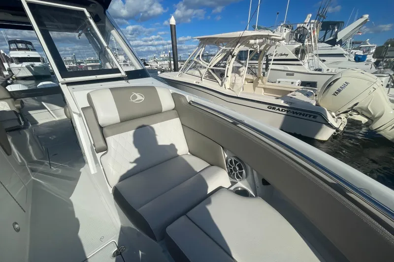 Slide: The Image of Interior view of 2022 Finseeker 280 DC boat cockpit with steering wheel and controls. - 23