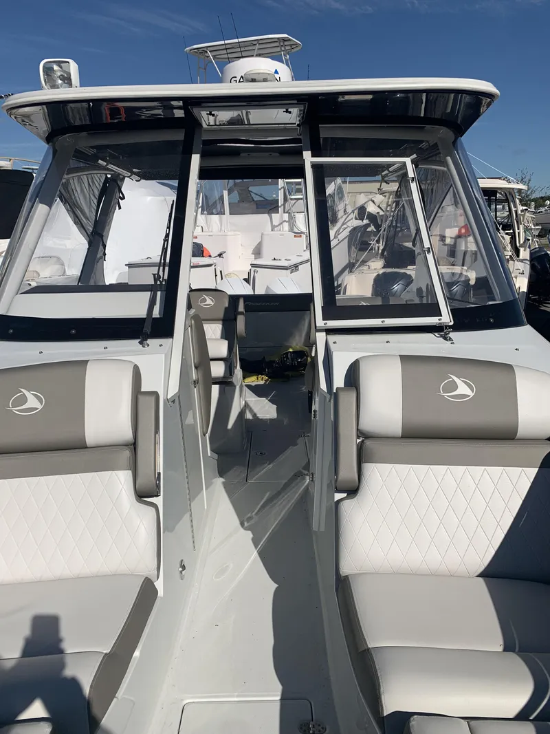 Slide: The Image of 2022 Finseeker 280 DC boat interior with seating and open cabin view. - 24