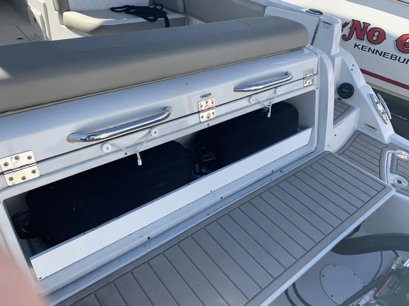 Slide: The Image of 2022 Finseeker 280 DC boat interior with seating, docked near other boats. - 28