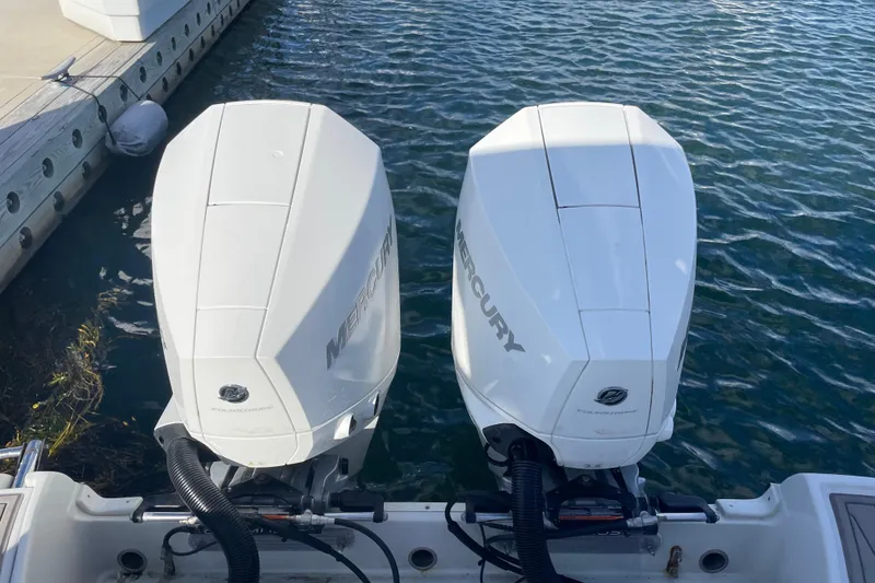 Slide: The Image of 2022 Finseeker 280 DC boat interior with cushioned seating and cup holders. - 31