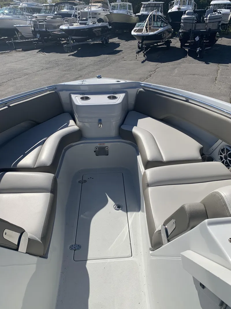 Slide: The Image of 2022 Finseeker 280 DC boat docked in a marina under a clear blue sky. - 4