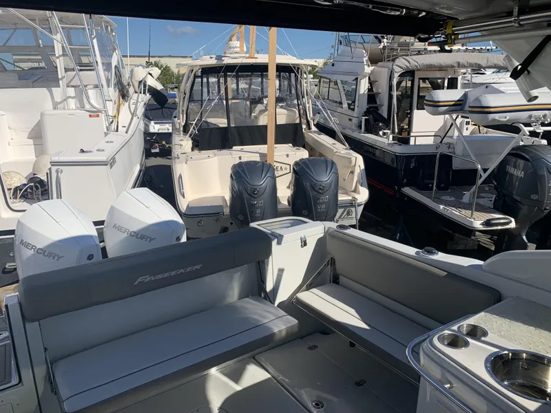 Slide: The Image of 2022 Finseeker 280 DC boat interior with seating and kitchenette area. - 6