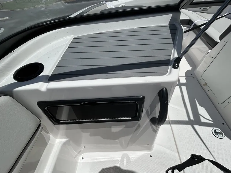 Slide: The Image of 2022 Yamaha SX190 boat interior with cup holder and storage compartment. - 11