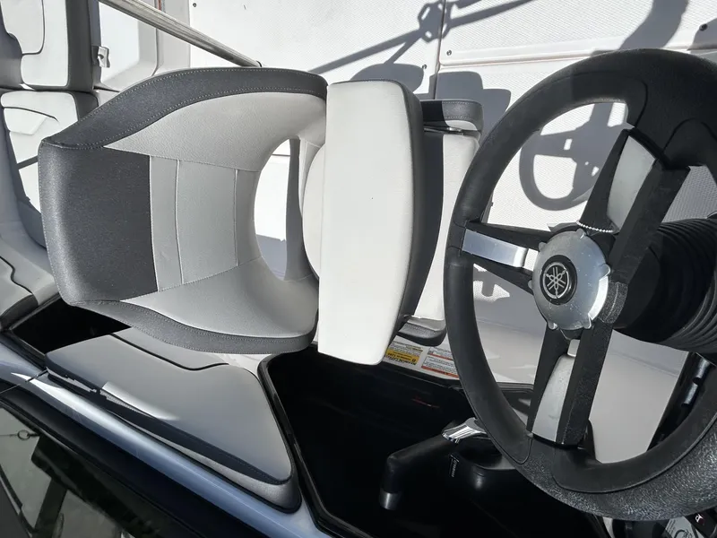 Slide: The Image of 2022 Yamaha Boats SX190 steering wheel and seat, showcasing modern design and comfort. - 12