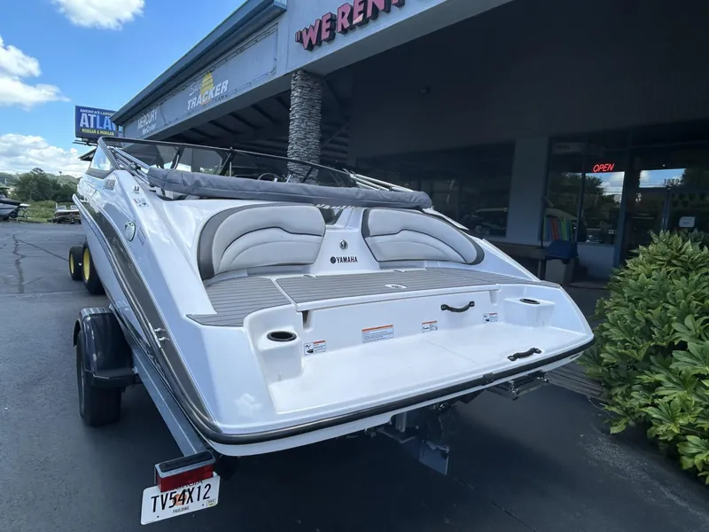 Slide: The Image of 2022 Yamaha SX190 boat on trailer outside dealership, rear view. - 2