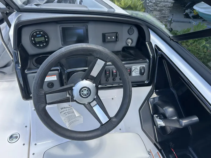 Slide: The Image of 2022 Yamaha SX190 boat dashboard with steering wheel and control panel. - 5