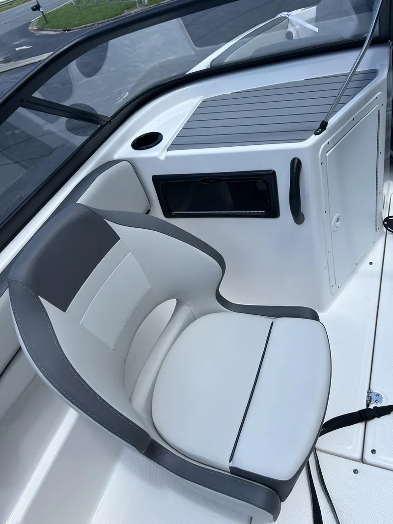 Slide: The Image of 2022 Yamaha Boats SX190 interior with gray and white seating and storage compartment. - 6