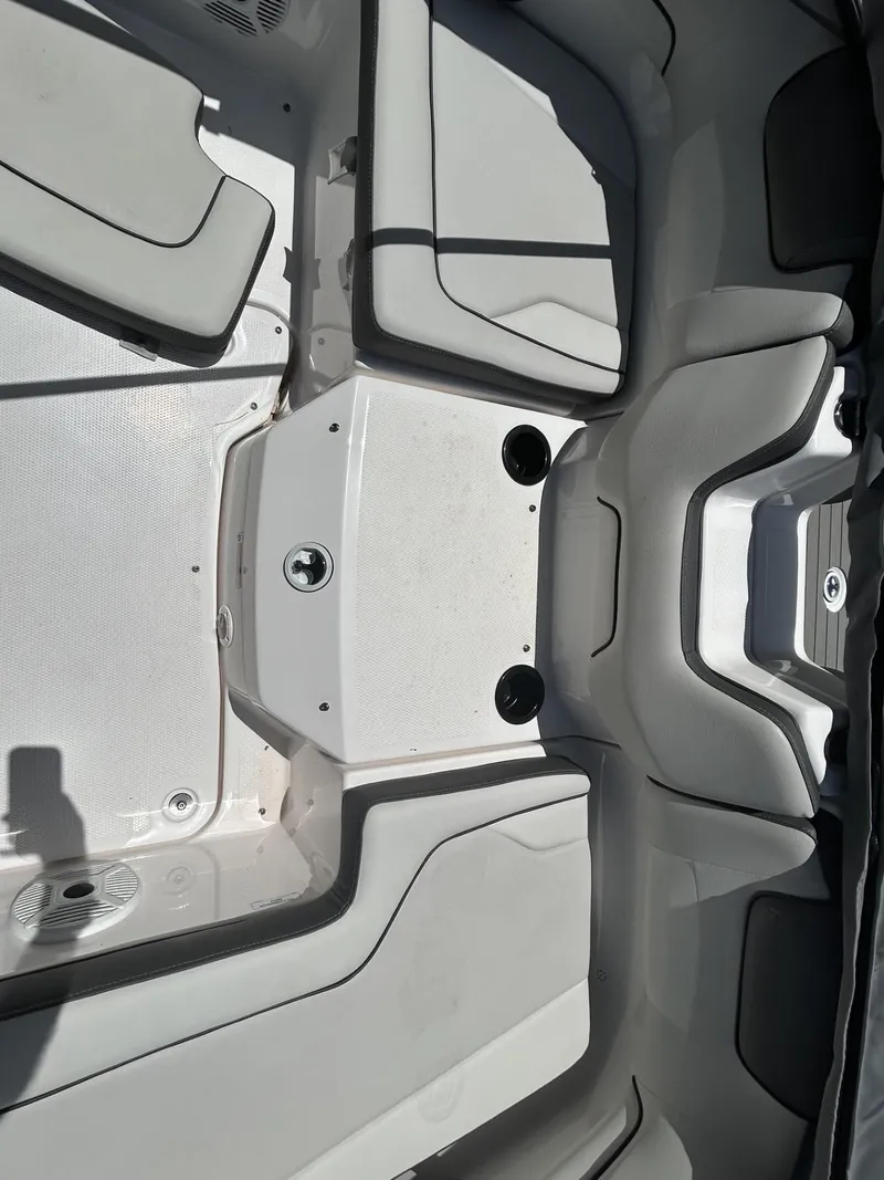 Slide: The Image of 2022 Yamaha Boats SX190 interior seating area with cup holders and sleek design. - 9