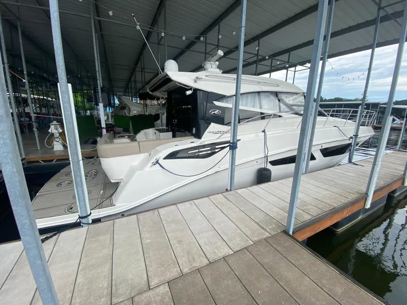 Slide: The Image of 2015 Sea Ray 470 Sundancer yacht docked in a covered marina. - 10