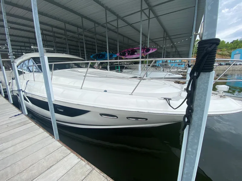 Slide: The Image of 2015 Sea Ray 470 Sundancer yacht docked under a covered marina. - 11
