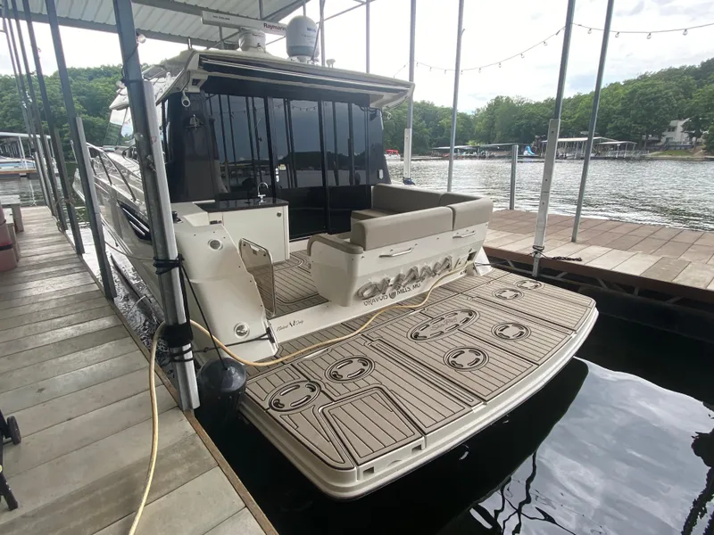 Slide: The Image of 2015 Sea Ray 470 Sundancer docked, featuring spacious deck and luxurious seating. - 12