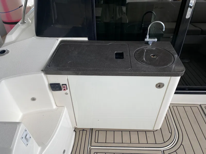 Slide: The Image of Outdoor kitchenette on 2015 Sea Ray 470 Sundancer yacht with sink and countertop. - 14