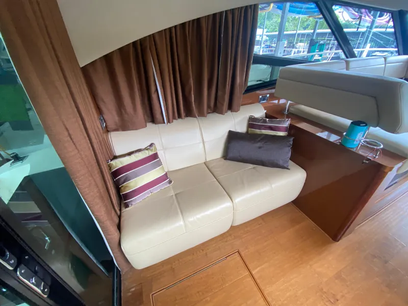 Slide: The Image of Luxurious interior of 2015 Sea Ray 470 Sundancer with cream leather sofa and striped cushions. - 16