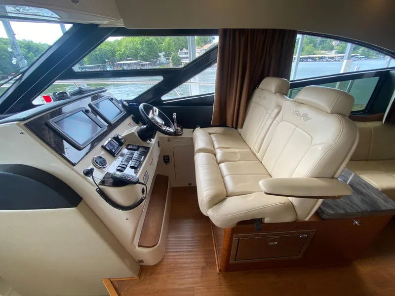 Slide: The Image of Helm of 2015 Sea Ray 470 Sundancer with leather seating and modern controls. - 19