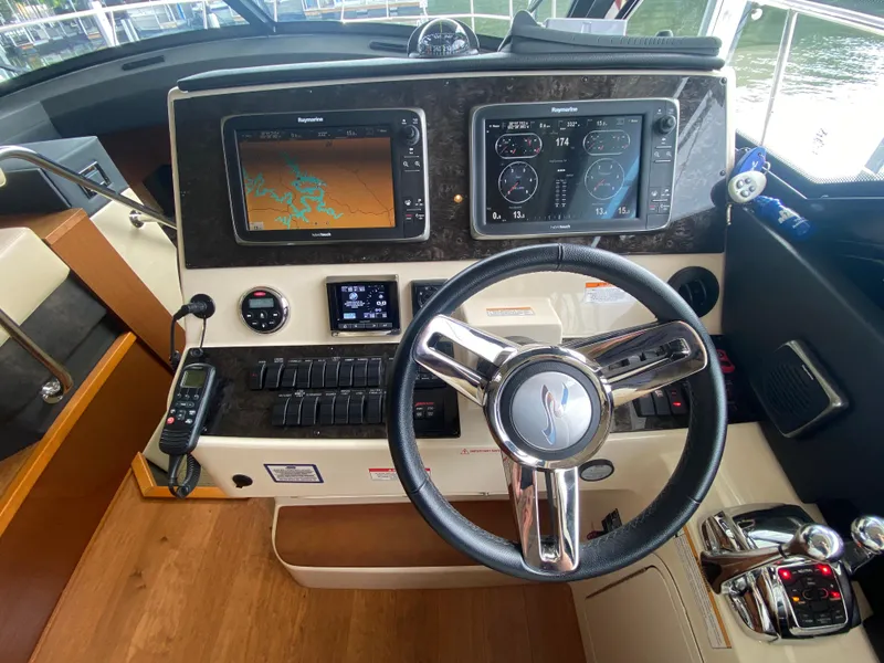 Slide: The Image of Helm of 2015 Sea Ray 470 Sundancer with navigation screens and controls. - 20