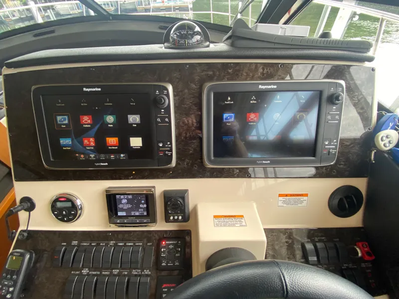 Slide: The Image of Helm of 2015 Sea Ray 470 Sundancer with Raymarine navigation displays and controls. - 24
