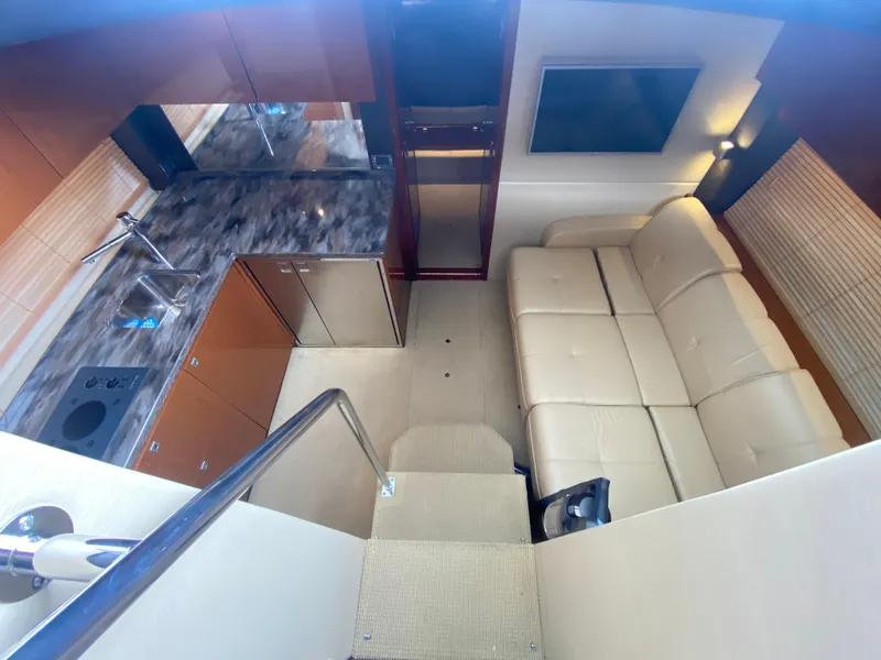 Slide: The Image of Luxurious interior of 2015 Sea Ray 470 Sundancer yacht with modern kitchen and comfortable seating. - 27