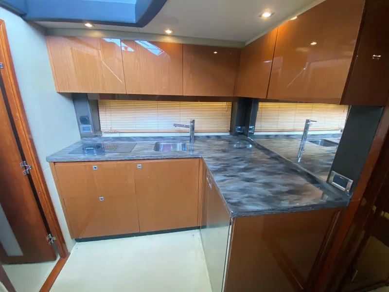 Slide: The Image of Luxurious kitchen interior of 2015 Sea Ray 470 Sundancer yacht with modern cabinetry. - 28
