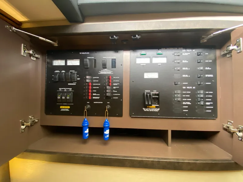 Slide: The Image of Electrical control panel inside 2015 Sea Ray 470 Sundancer yacht, featuring switches and indicators. - 31