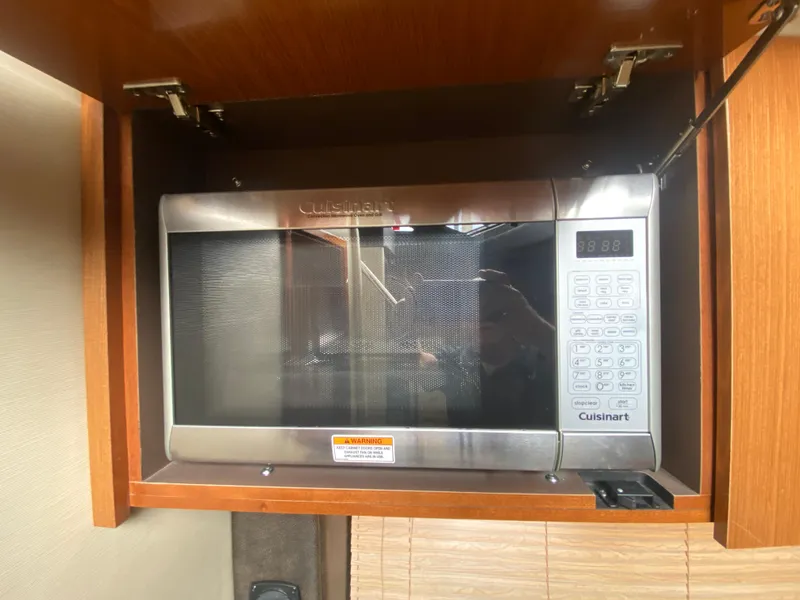 Slide: The Image of Cuisinart microwave in 2015 Sea Ray 470 Sundancer yacht kitchen cabinet. - 33