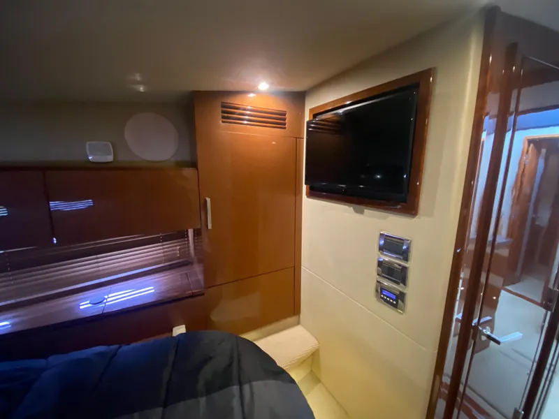 Slide: The Image of Luxurious interior of 2015 Sea Ray 470 Sundancer yacht with TV and wooden cabinetry. - 35