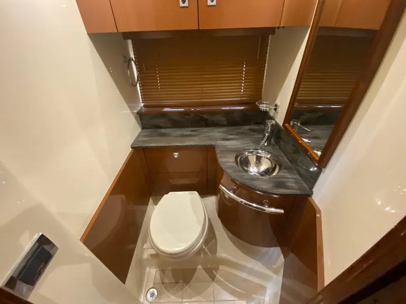 Slide: The Image of Luxurious bathroom in 2015 Sea Ray 470 Sundancer yacht with modern fixtures and wood accents. - 38