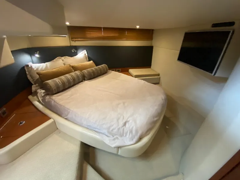 Slide: The Image of Luxurious bedroom interior of 2015 Sea Ray 470 Sundancer yacht with cozy bed and TV. - 43