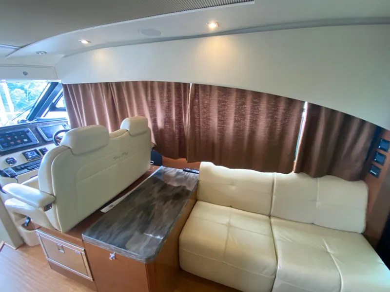 Slide: The Image of Interior of 2015 Sea Ray 470 Sundancer yacht with plush seating and modern dashboard. - 46