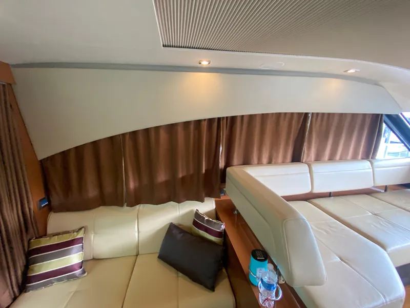Slide: The Image of Luxurious interior of 2015 Sea Ray 470 Sundancer with cream leather seating and brown curtains. - 47