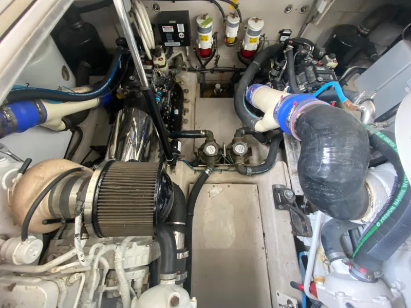 Slide: The Image of Engine compartment of 2015 Sea Ray 470 Sundancer with visible components and hoses. - 49