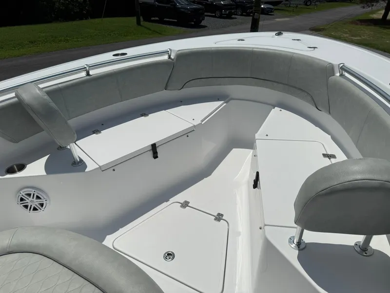 Slide: The Image of 2019 Sportsman Open 232 Center Console boat interior with cushioned seating and storage compartments. - 11