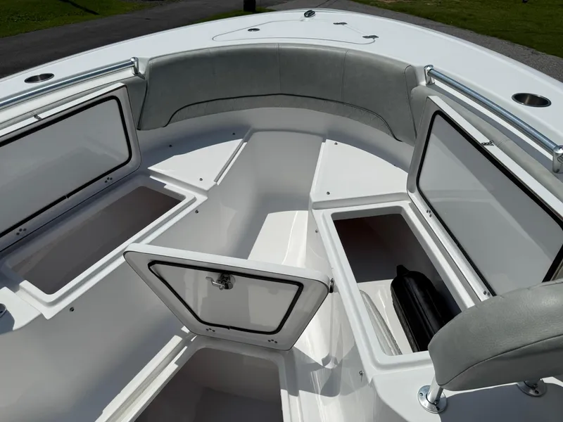 Slide: The Image of 2019 Sportsman Open 232 Center Console boat with open storage compartments and cushioned seating. - 13
