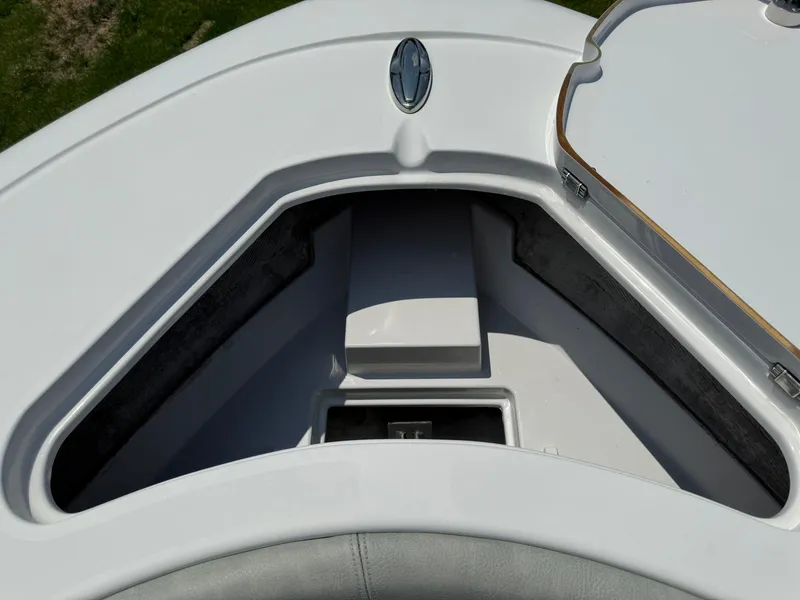 Slide: The Image of 2019 Sportsman Open 232 Center Console boat storage compartment, open lid view. - 14