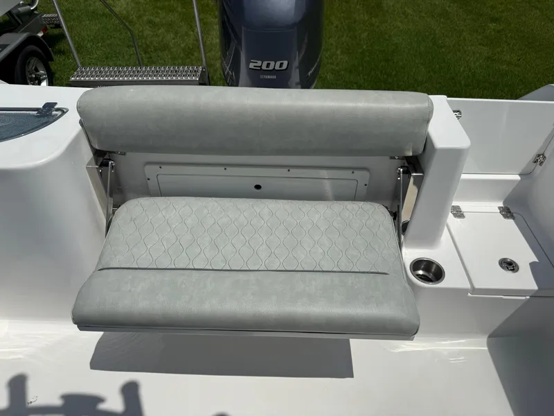 Slide: The Image of 2019 Sportsman Open 232 Center Console boat seat with Yamaha 200 engine in background. - 17