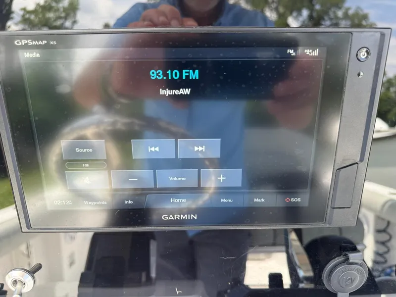 Slide: The Image of Garmin GPSMAP X5 displaying FM radio on Sportsman Open 232 Center Console, 2019 model. - 23