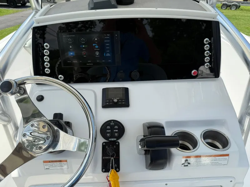 Slide: The Image of 2019 Sportsman Open 232 Center Console dashboard with steering wheel and Garmin display. - 25