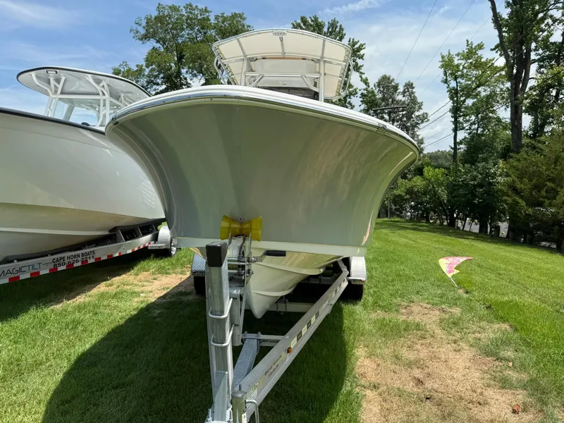 Slide: The Image of 2019 Sportsman Open 232 Center Console boat on trailer, parked on grass. - 4