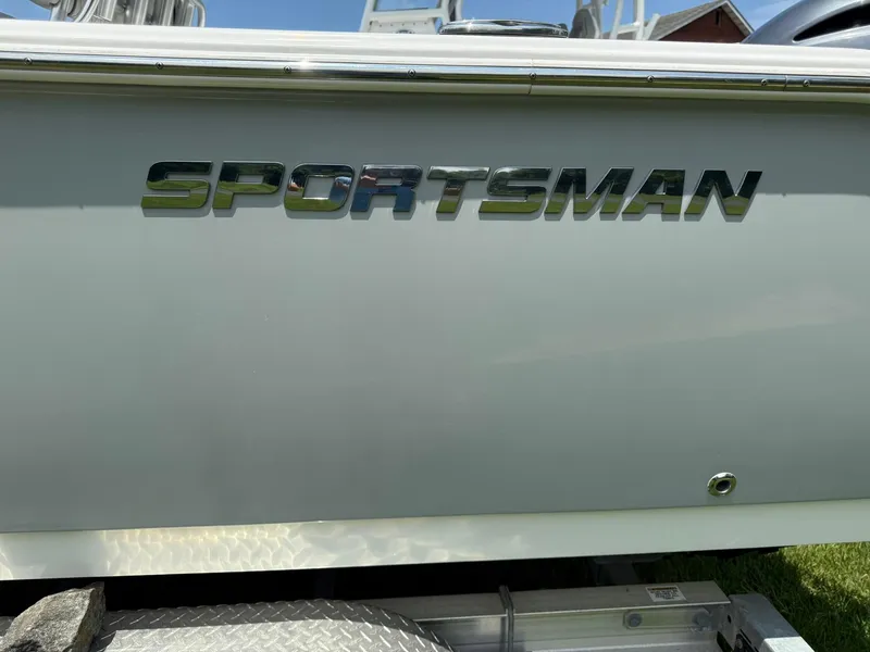 Slide: The Image of 2019 Sportsman Open 232 Center Console boat with chrome logo detail. - 6