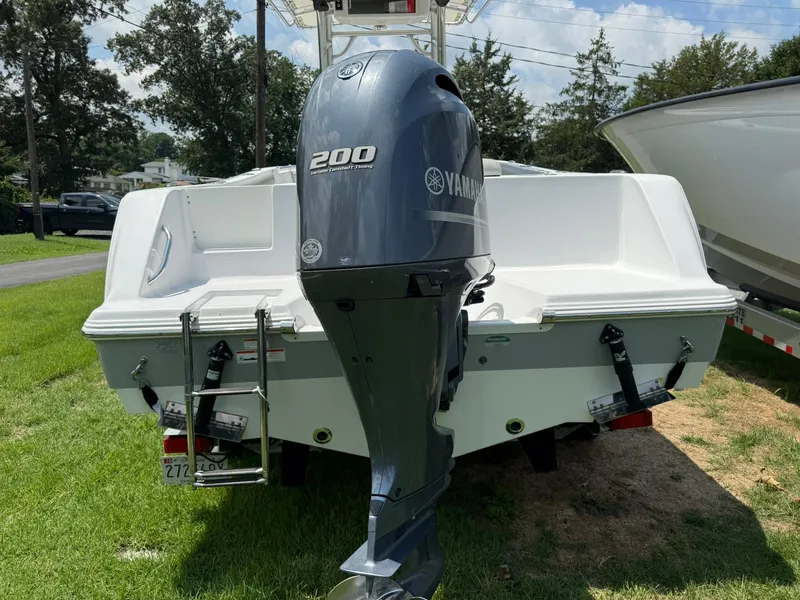 Slide: The Image of 2019 Sportsman Open 232 Center Console boat with Yamaha 200 engine, parked on grass. - 8
