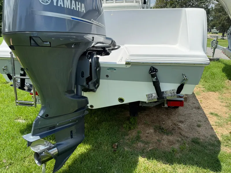 Slide: The Image of 2019 Sportsman Open 232 Center Console boat with Yamaha outboard motor on grass. - 9