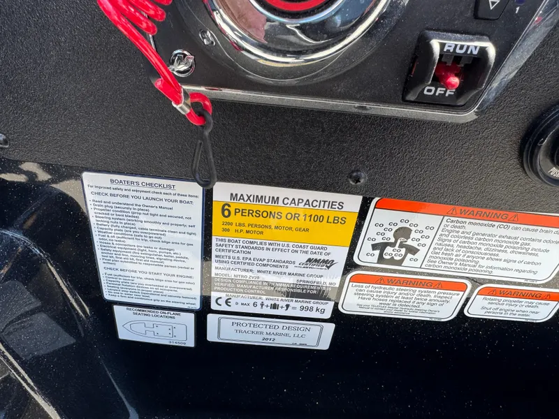 Slide: The Image of Control panel of 2025 Nitro ZV20 Sport Pro boat with safety and capacity labels. - 10