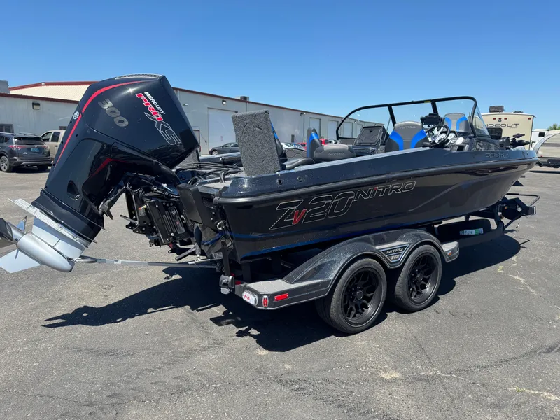 Slide: The Image of 2025 Nitro ZV20 Sport Pro boat with powerful outboard motor, parked on a trailer. - 4