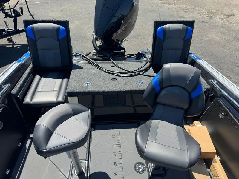 Slide: The Image of 2025 Nitro ZV20 Sport Pro boat interior with black and blue seating and motor. - 6