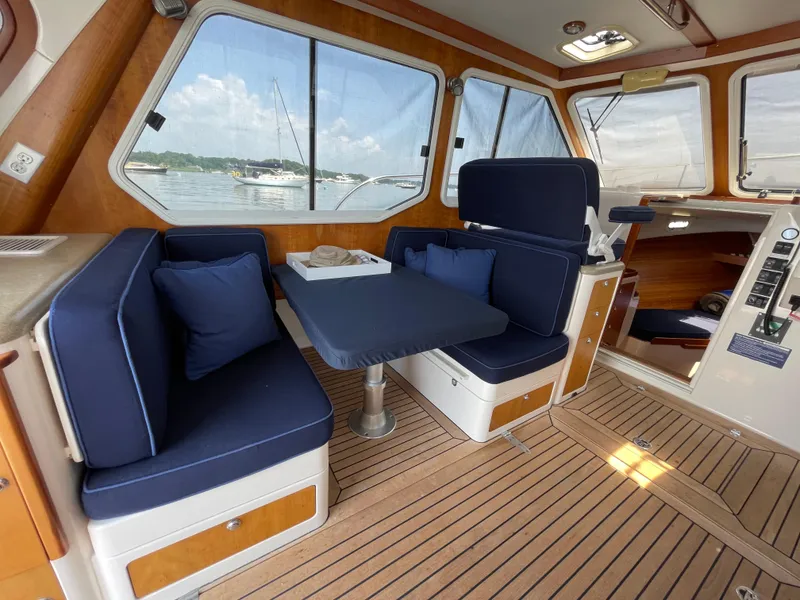 Slide: The Image of Cozy interior of 2007 True North 38 boat with blue seating and wooden flooring. - 10